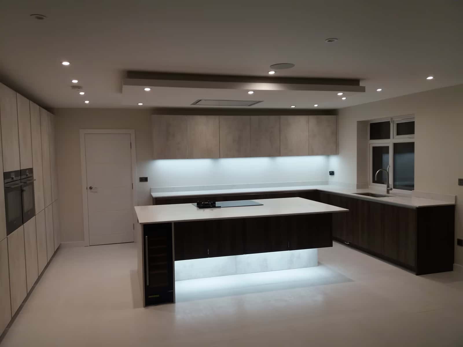 Completed contemporary kitchen renovation in West London with island and full-height units