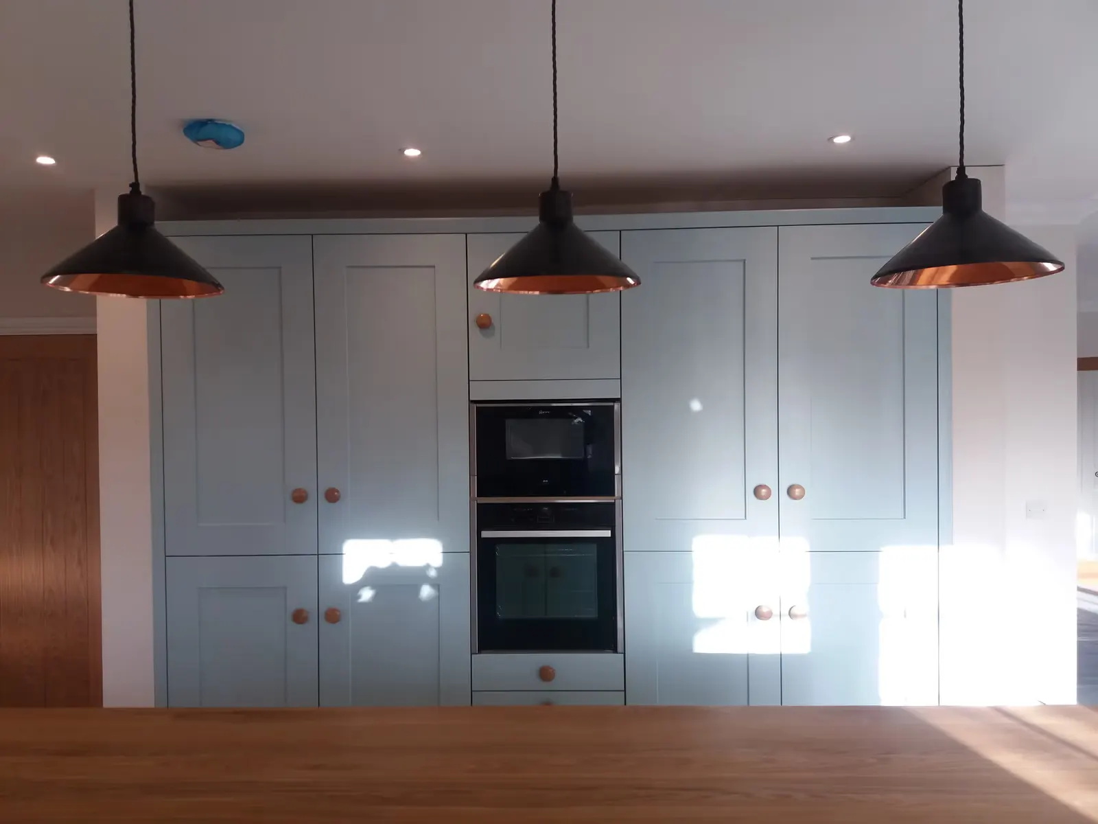 Shaker Kitchen Renovation with Copper Pendants — image 4